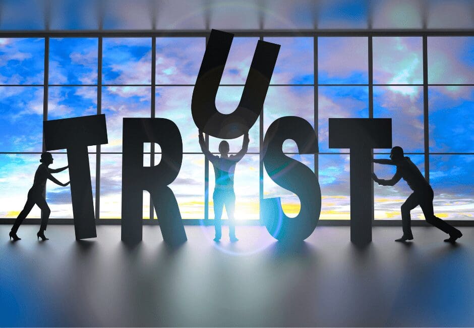 Silhouettes of people assembling large letters to form the word TRUST, symbolizing Agile Solutions’ commitment to building trustworthy, authentic brand identities for service-based businesses.